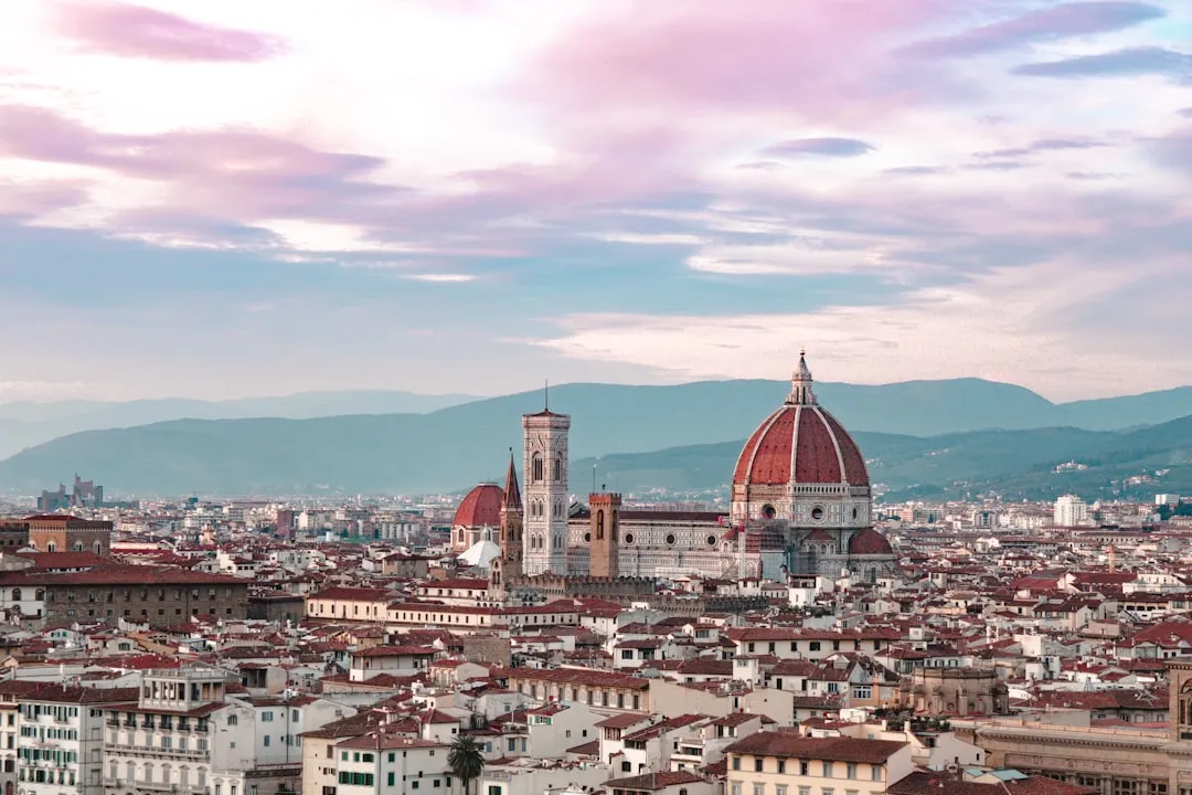 Florence cityscape at sunset with the illuminated Duomo cathedral dominating the skyline