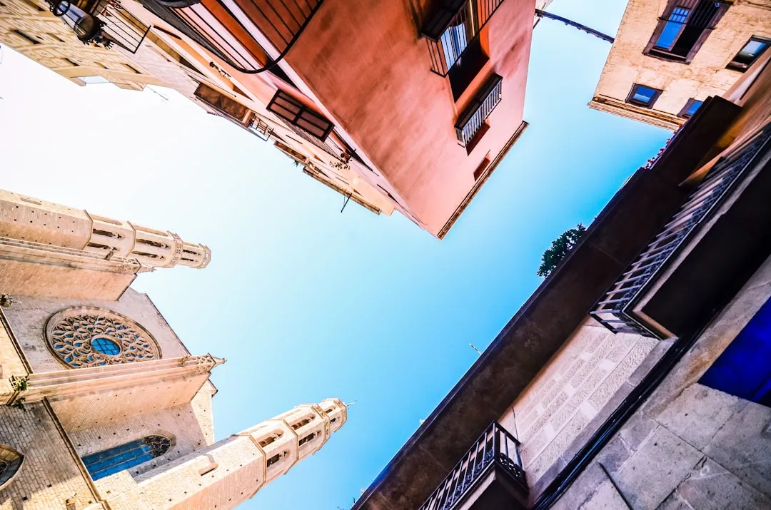 Upward perspective of church tower against bright blue sky