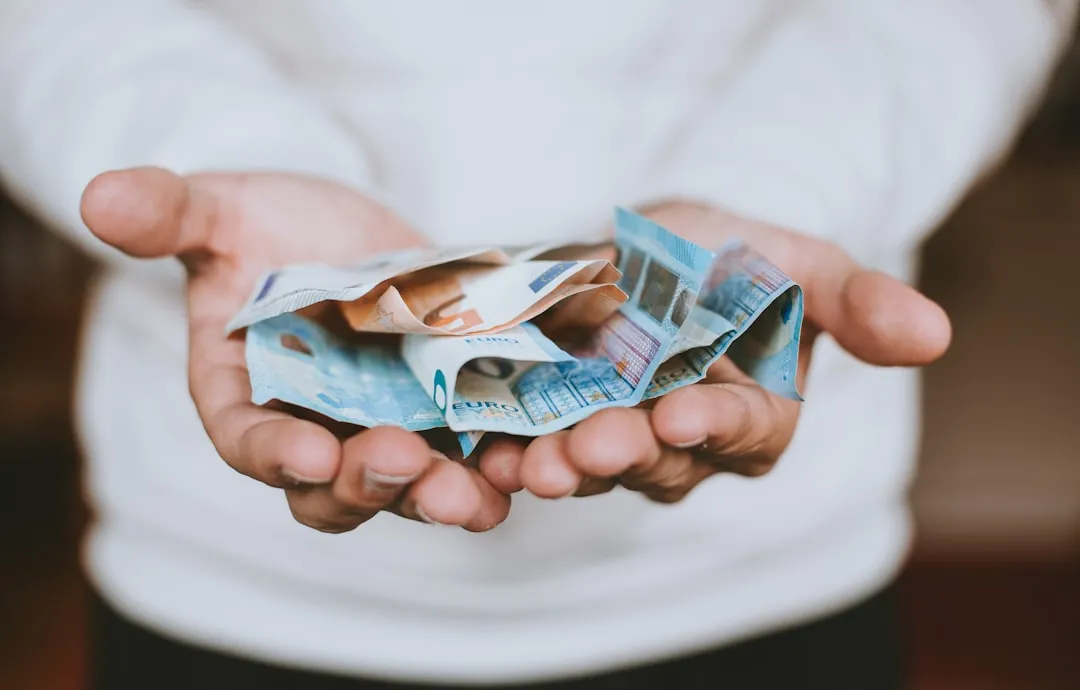 A guy holding euros in his hands