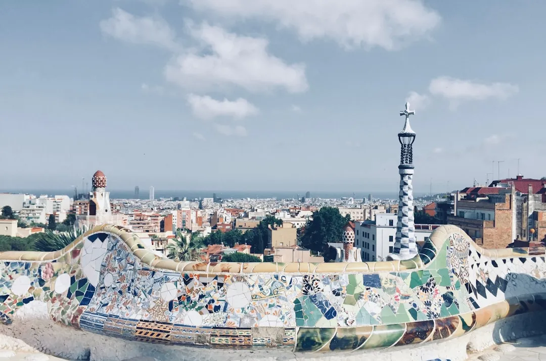 Mosaic-covered serpentine bench at Park Güell overlooking Barcelona