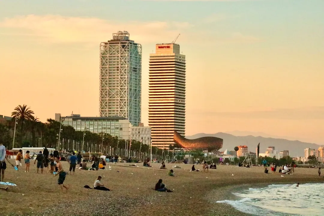Modern twin towers along Barcelona's waterfront at sunset